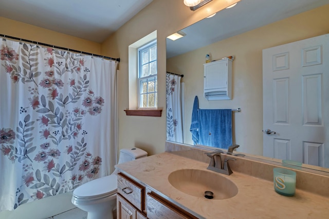 bathroom featuring toilet and vanity