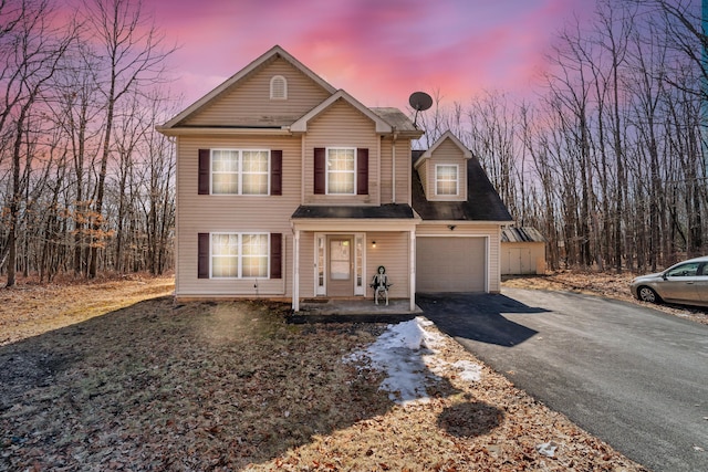 traditional-style house with a garage and driveway