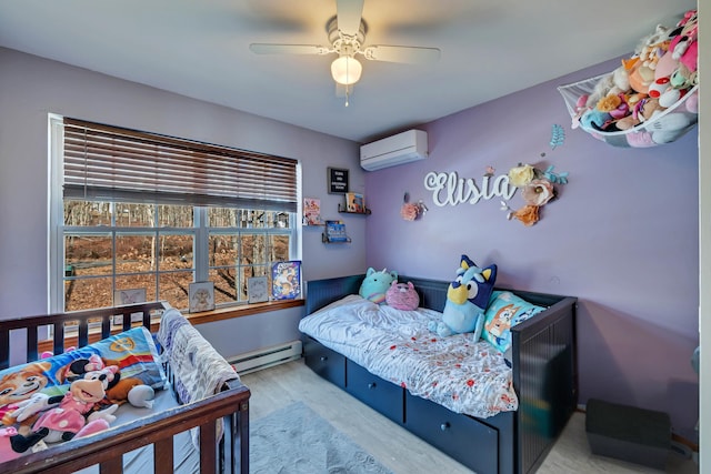 bedroom with an AC wall unit, wood finished floors, a ceiling fan, and a baseboard radiator