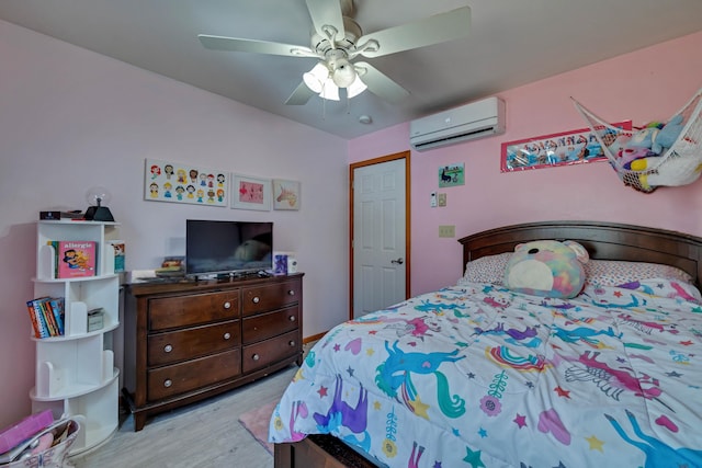 bedroom featuring an AC wall unit, ceiling fan, and wood finished floors