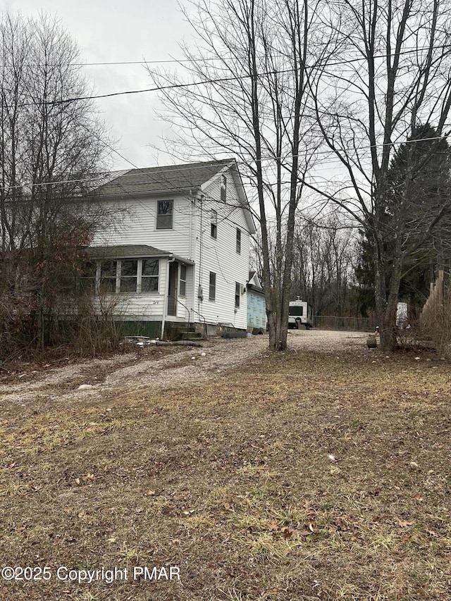 view of front of home featuring roof with shingles