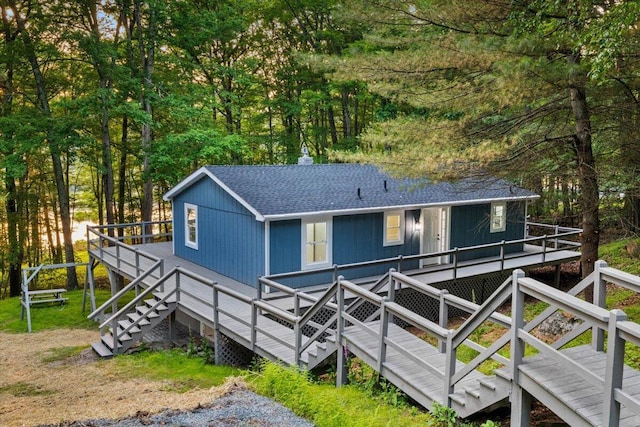173 Water View Dr, Hawley, PA 18428 - view of front of property with a deck, stairway, roof with shingles, and a chimney
