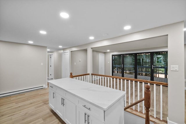 173 Water View Dr, Hawley, PA 18428 - kitchen featuring a baseboard radiator, white cabinets, recessed lighting, light wood-style floors, and light stone countertops