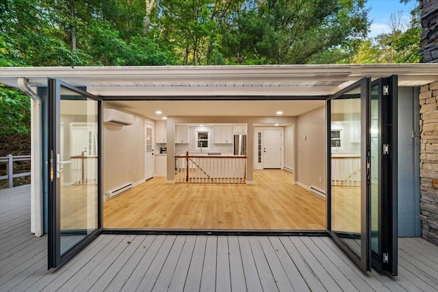173 Water View Dr, Hawley, PA 18428 - wooden terrace featuring a wall unit AC and baseboard heating
