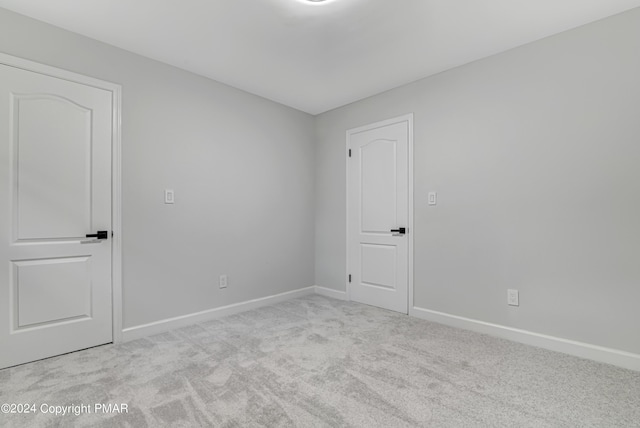 spare room with carpet floors and baseboards