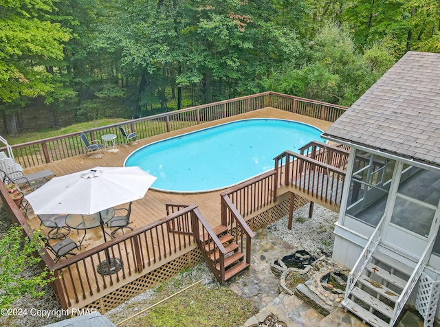 view of pool with a fenced in pool, outdoor dining area, and a deck