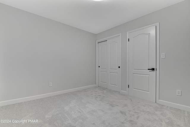 unfurnished bedroom with carpet floors and baseboards