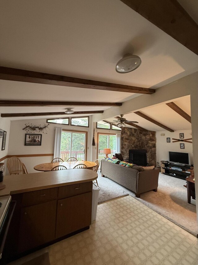 281 Fern Ridge Rd, Blakeslee, PA 18610 - kitchen featuring range with electric stovetop, dark brown cabinets, a ceiling fan, a stone fireplace, and light carpet