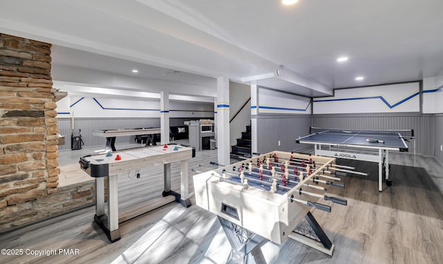 recreation room featuring recessed lighting, a wainscoted wall, and wood finished floors