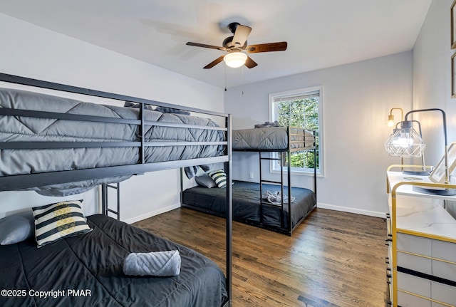 bedroom with a ceiling fan, baseboards, and wood finished floors