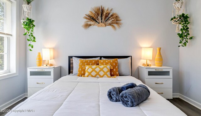 bedroom with dark hardwood / wood-style flooring