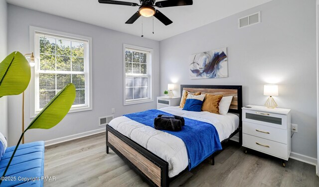 bedroom with hardwood / wood-style flooring and ceiling fan