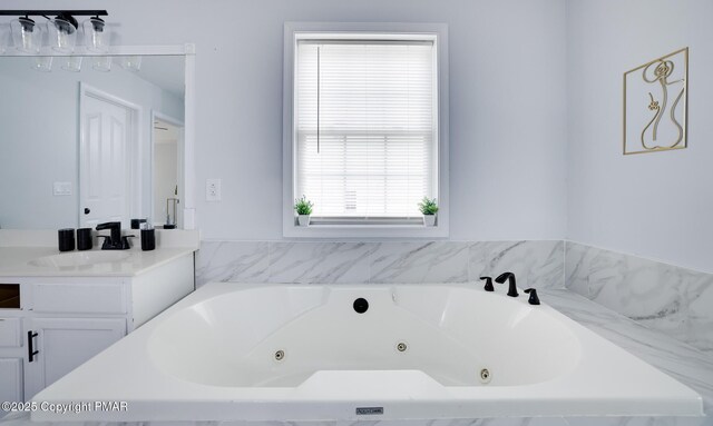 bathroom with a relaxing tiled tub and vanity