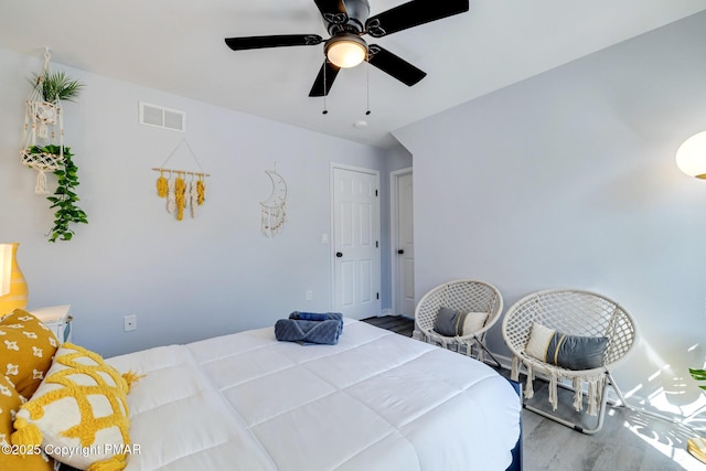 bedroom featuring wood-type flooring and ceiling fan