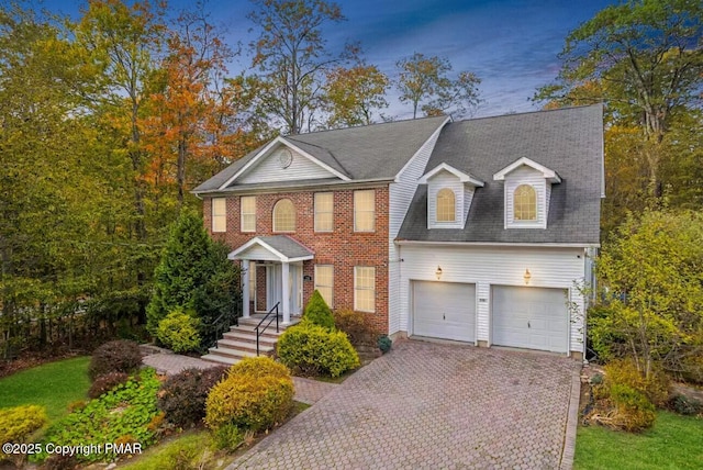 view of front of property with an attached garage and decorative driveway