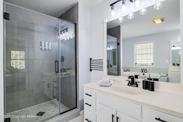 bathroom with a stall shower and vanity