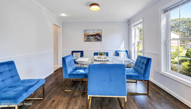 dining area with baseboards, crown molding, and wood finished floors