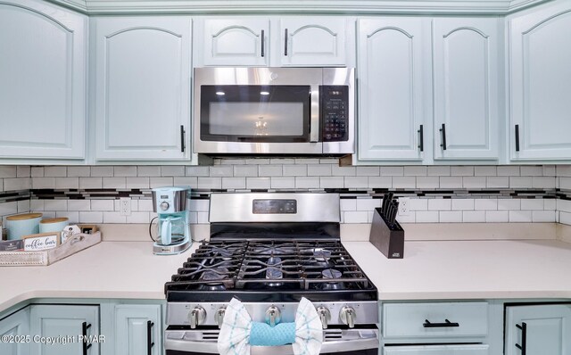 kitchen with decorative backsplash, dishwasher, sink, and kitchen peninsula