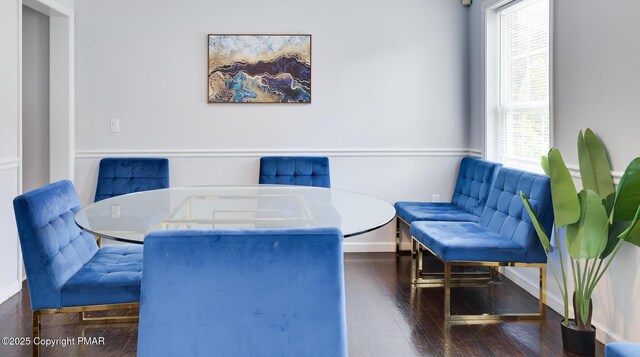 dining area with baseboards and wood finished floors