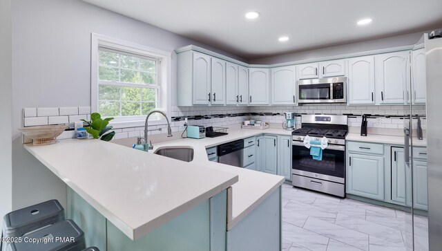 kitchen featuring white cabinetry, stainless steel appliances, and backsplash