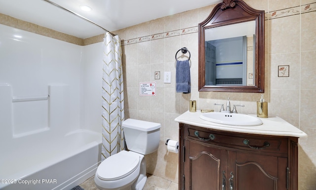 full bathroom with shower / bath combo, tile walls, vanity, and toilet