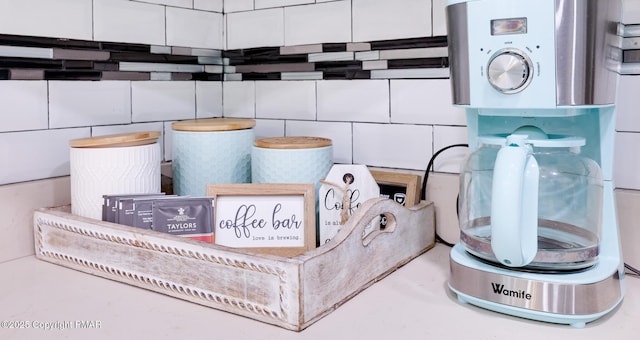 room details with white cabinetry and tasteful backsplash