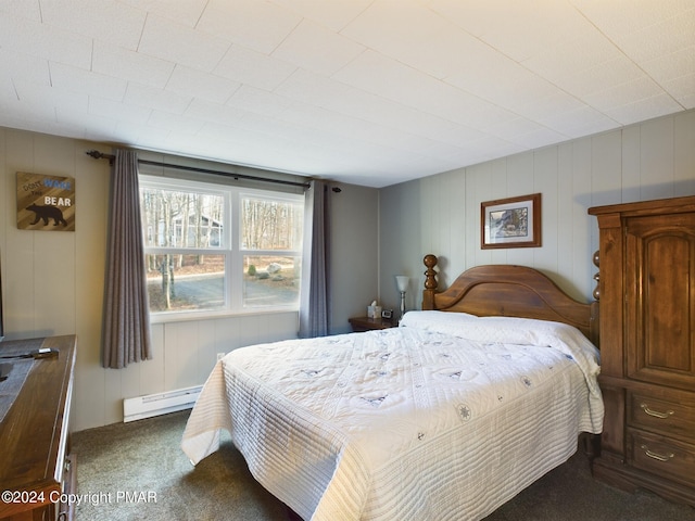 bedroom with carpet floors and a baseboard heating unit