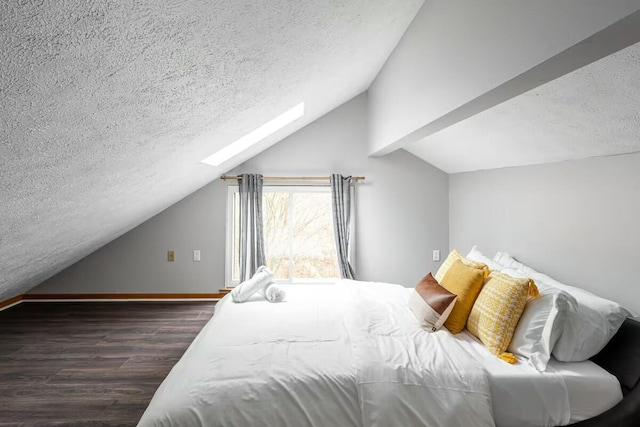 bedroom featuring lofted ceiling with skylight, a textured ceiling, baseboards, and dark wood-style flooring