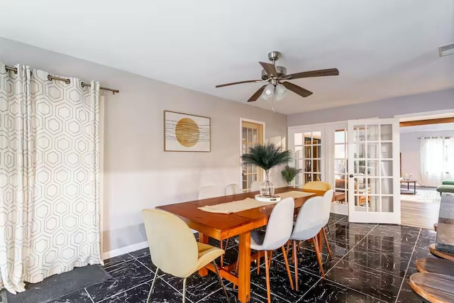 dining area featuring baseboards, marble finish floor, french doors, and ceiling fan