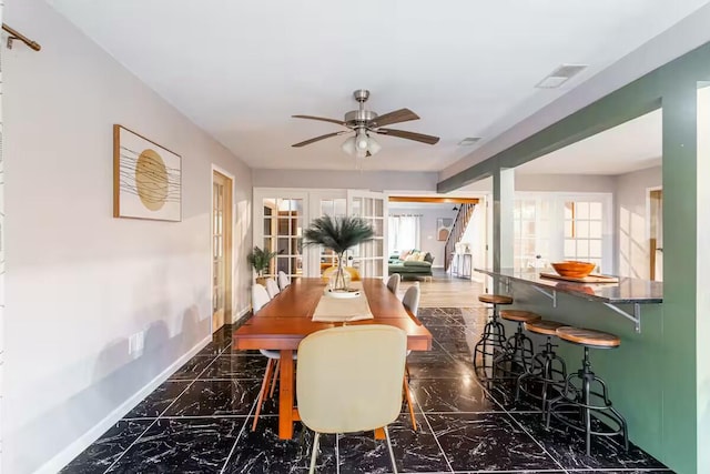 dining area with visible vents, baseboards, ceiling fan, french doors, and marble finish floor