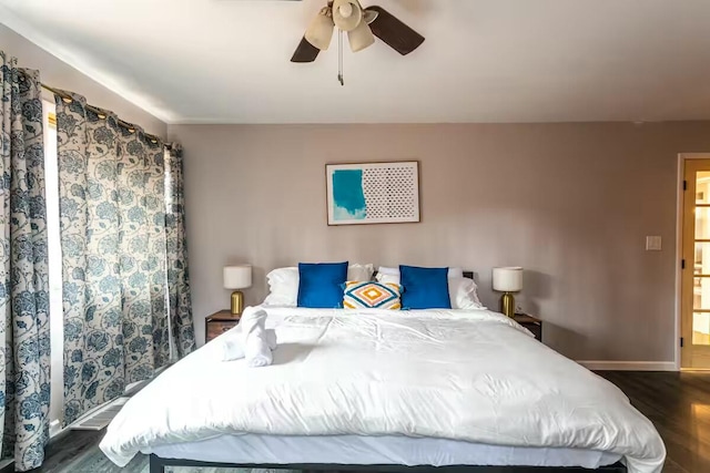 bedroom featuring dark wood-style floors, baseboards, and ceiling fan