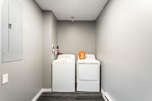 laundry room with baseboards, dark wood finished floors, laundry area, electric panel, and washing machine and dryer