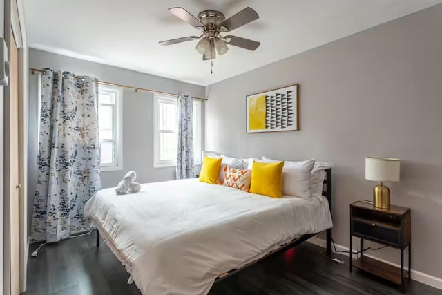 bedroom with baseboards, dark wood-style flooring, and ceiling fan