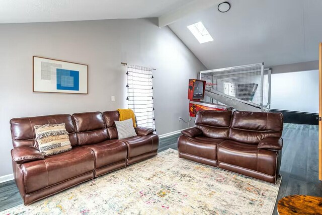 living area featuring lofted ceiling with skylight, wood finished floors, and baseboards