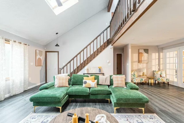 living area with stairway, high vaulted ceiling, and wood finished floors