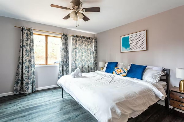 bedroom with ceiling fan, baseboards, and wood finished floors