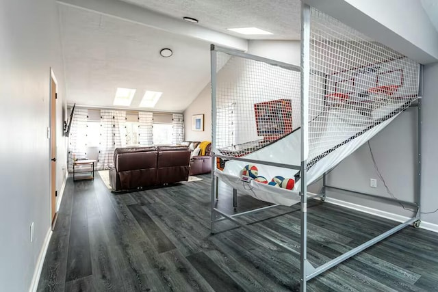 recreation room with vaulted ceiling, wood finished floors, and baseboards