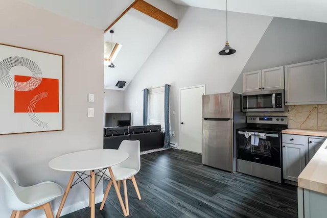 kitchen featuring dark wood finished floors, stainless steel appliances, light countertops, decorative light fixtures, and tasteful backsplash