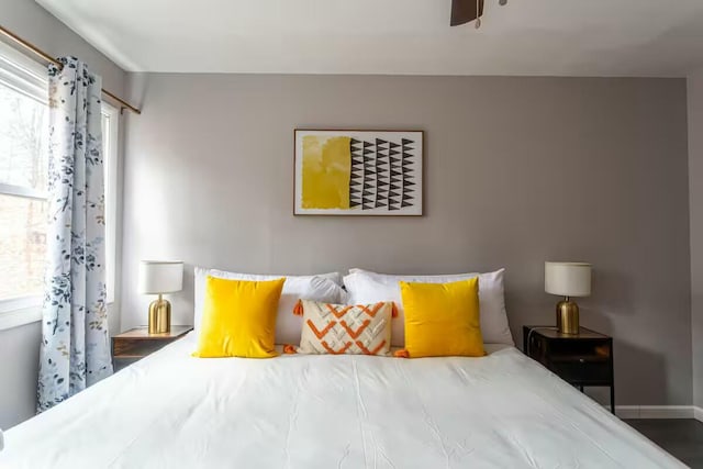 bedroom with multiple windows and baseboards