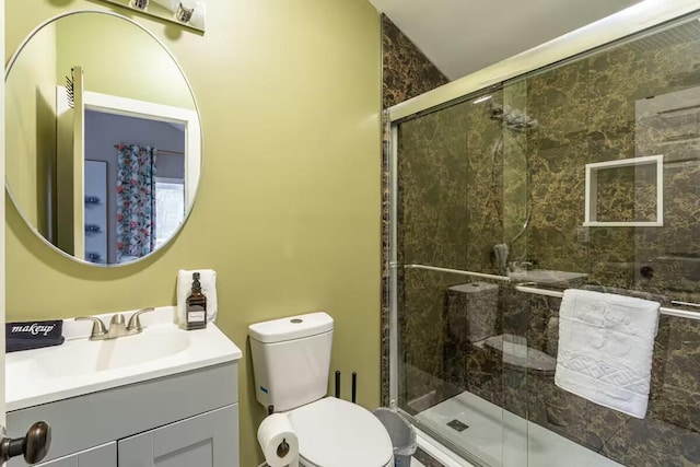 full bath featuring vanity, toilet, and a shower stall