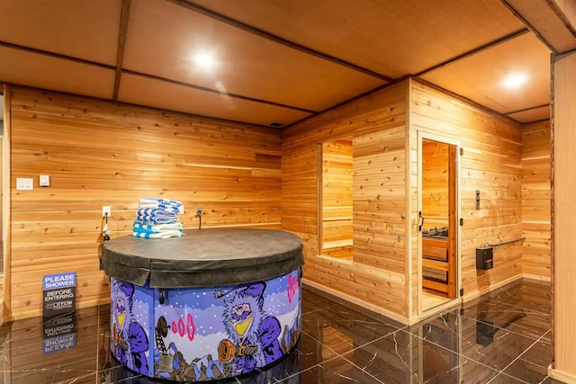 bathroom featuring a sauna and wood walls