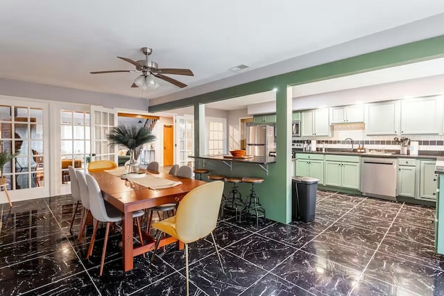 dining room featuring visible vents, marble finish floor, and ceiling fan