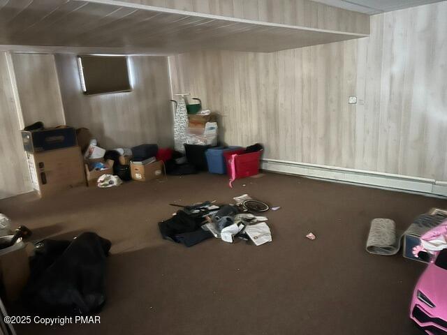 basement featuring a baseboard heating unit