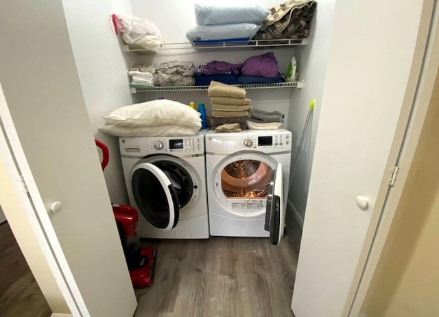 laundry area featuring independent washer and dryer and wood finished floors