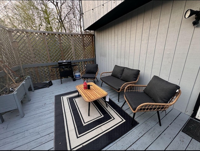 deck featuring a grill and outdoor lounge area