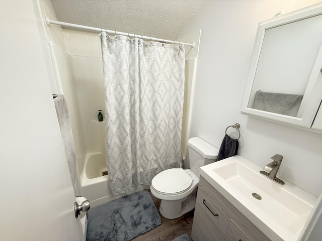 bathroom with toilet, a textured ceiling, shower / bathtub combination with curtain, vanity, and wood finished floors