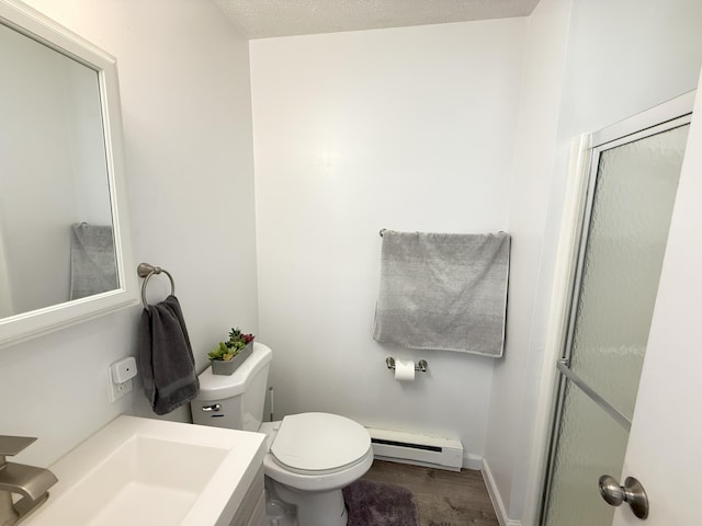 full bathroom featuring a baseboard radiator, toilet, a shower with door, and vanity
