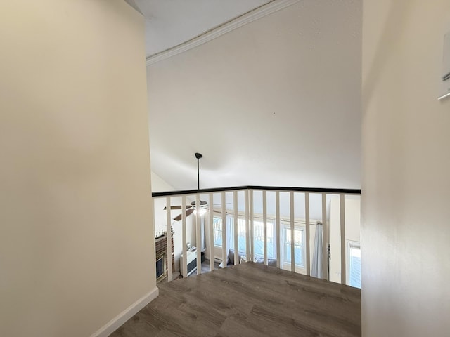 stairs featuring a ceiling fan, wood finished floors, baseboards, and crown molding