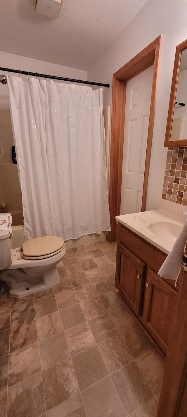 25 Byron Ln, Albrightsville, PA 18210 - bathroom with toilet, shower / bathtub combination with curtain, vanity, tasteful backsplash, and stone finish floors