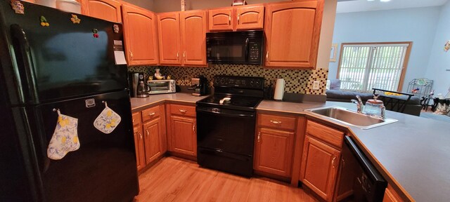 25 Byron Ln, Albrightsville, PA 18210 - kitchen featuring black appliances, a sink, light wood-style floors, and decorative backsplash